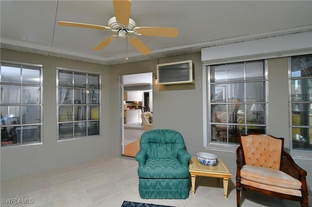 sitting room featuring an AC wall unit, crown molding, ceiling fan, and light tile patterned flooring