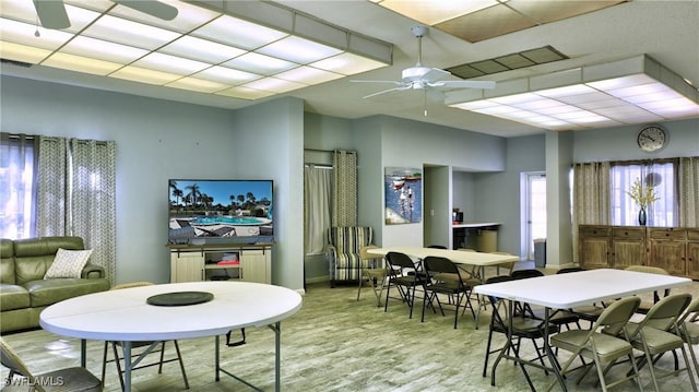 dining space with ceiling fan and light wood-type flooring