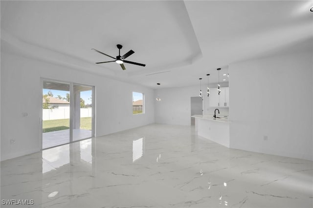 unfurnished room featuring ceiling fan and sink