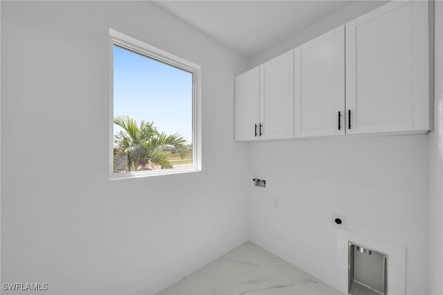 laundry area featuring electric dryer hookup and cabinets