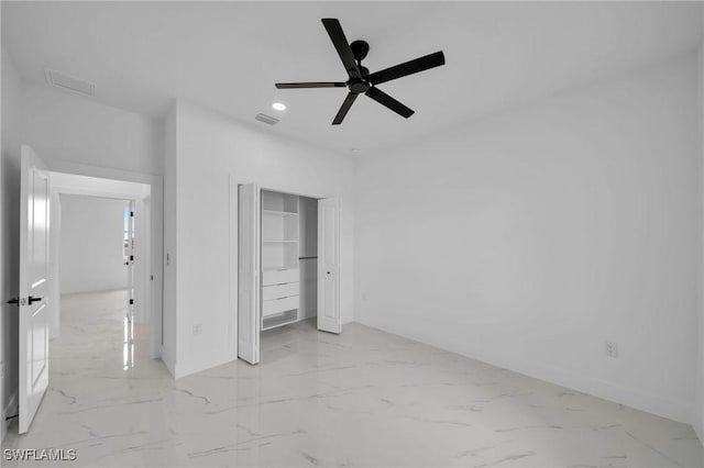 unfurnished bedroom with ceiling fan and a closet