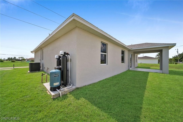 view of property exterior with a lawn and central AC unit