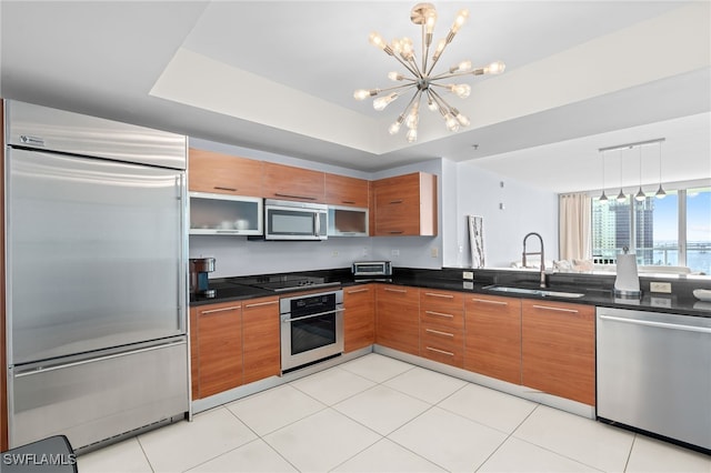 kitchen with sink, hanging light fixtures, an inviting chandelier, light tile patterned floors, and appliances with stainless steel finishes