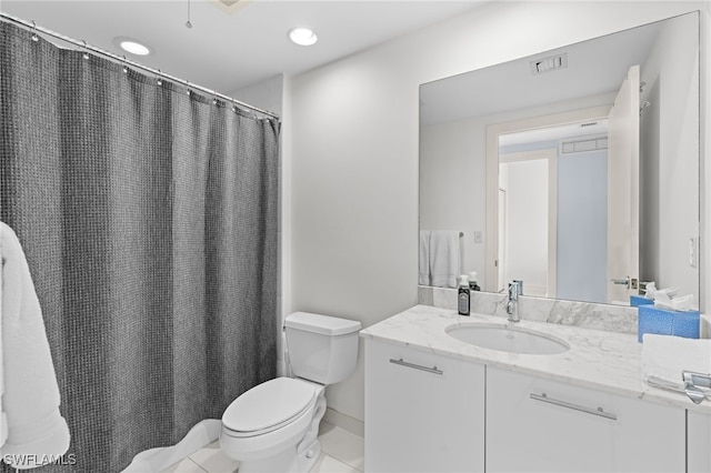 bathroom featuring tile patterned floors, vanity, and toilet