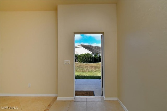 entryway with light tile patterned flooring