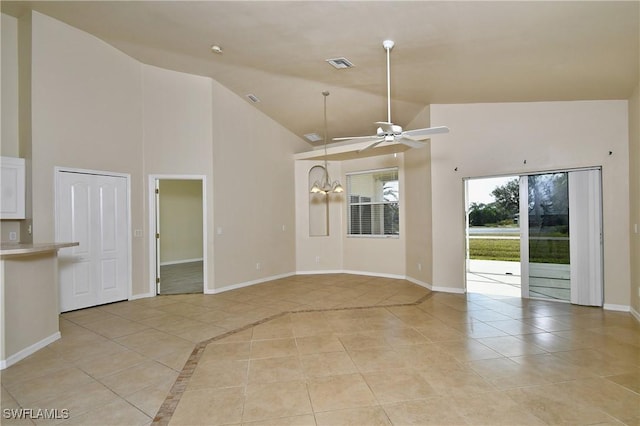 unfurnished living room with ceiling fan with notable chandelier, light tile patterned floors, and high vaulted ceiling