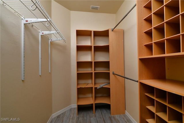 spacious closet with hardwood / wood-style floors