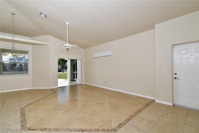 tiled empty room with ceiling fan and vaulted ceiling