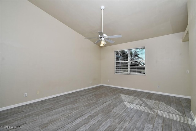 spare room with ceiling fan, dark hardwood / wood-style flooring, and lofted ceiling