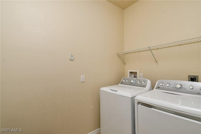 clothes washing area featuring independent washer and dryer