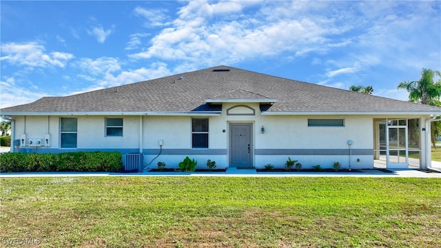 ranch-style house with central AC unit and a front yard