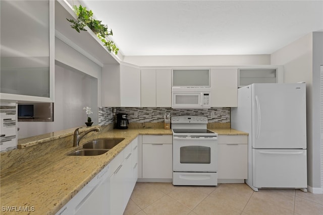 kitchen featuring backsplash, light stone counters, white appliances, sink, and white cabinets