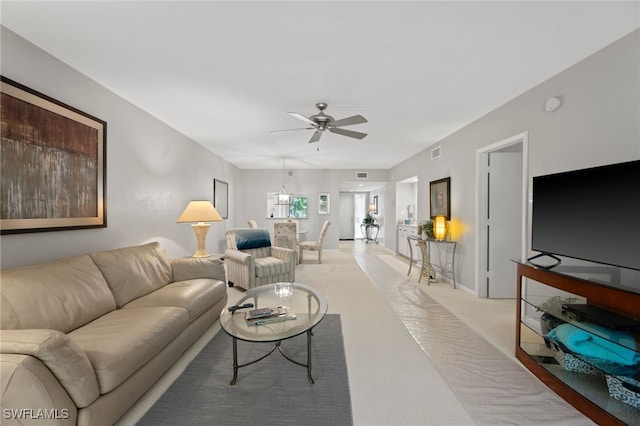 living room with light colored carpet and ceiling fan