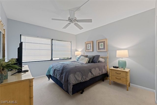 bedroom featuring ceiling fan and light carpet