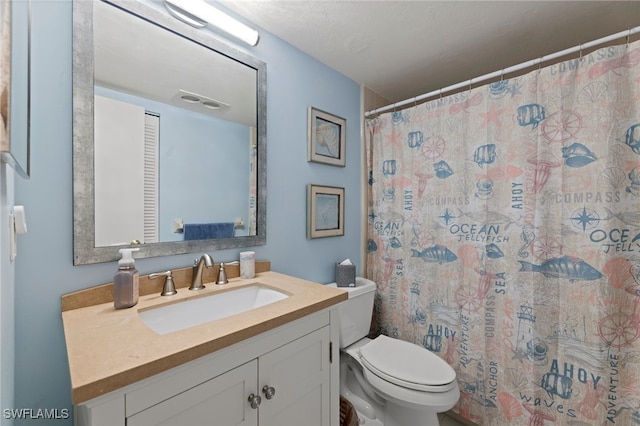 bathroom with walk in shower, vanity, and toilet