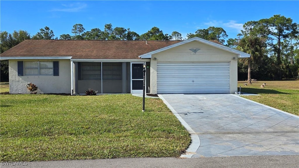 ranch-style house featuring a garage and a front lawn