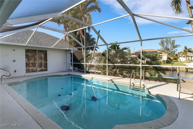 view of swimming pool with a water view and a lanai