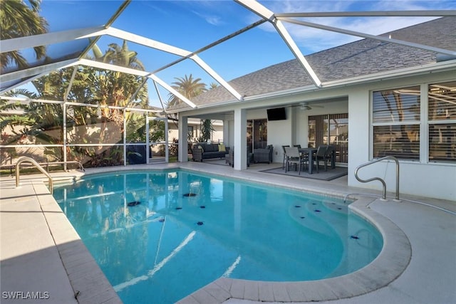 view of swimming pool with ceiling fan, a lanai, an outdoor hangout area, and a patio