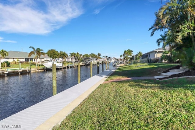 view of dock featuring a yard and a water view