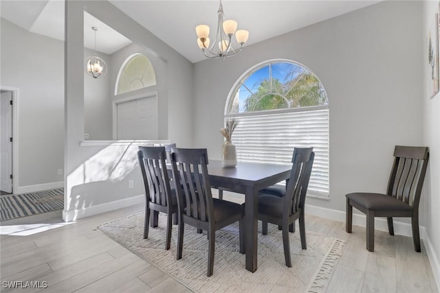 dining area with a chandelier and light hardwood / wood-style flooring