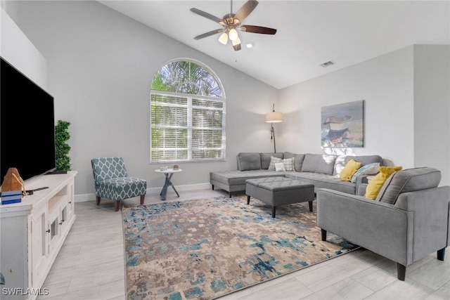 living room with ceiling fan and vaulted ceiling