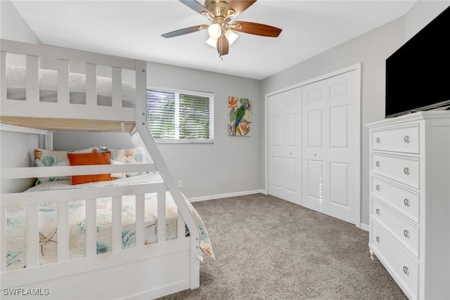 carpeted bedroom with ceiling fan and a closet