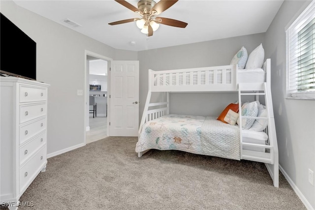 carpeted bedroom with ceiling fan