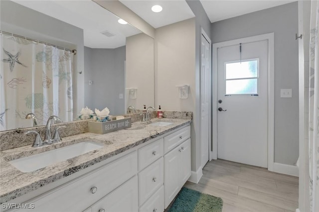 bathroom with vanity and wood-type flooring