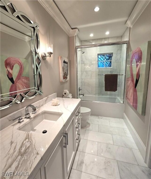 full bathroom featuring enclosed tub / shower combo, toilet, vanity, marble finish floor, and crown molding