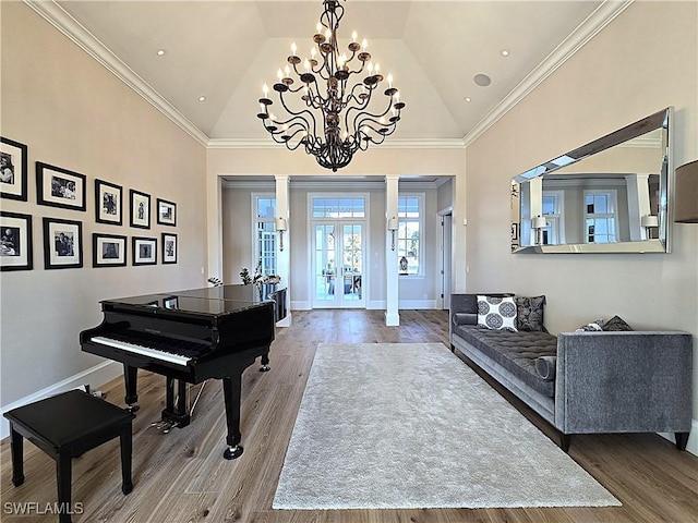 entryway with decorative columns, baseboards, wood finished floors, and french doors