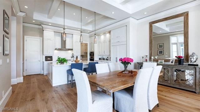 dining space featuring recessed lighting, a towering ceiling, baseboards, light wood-type flooring, and crown molding