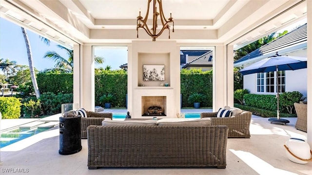 view of patio with an outdoor living space with a fireplace