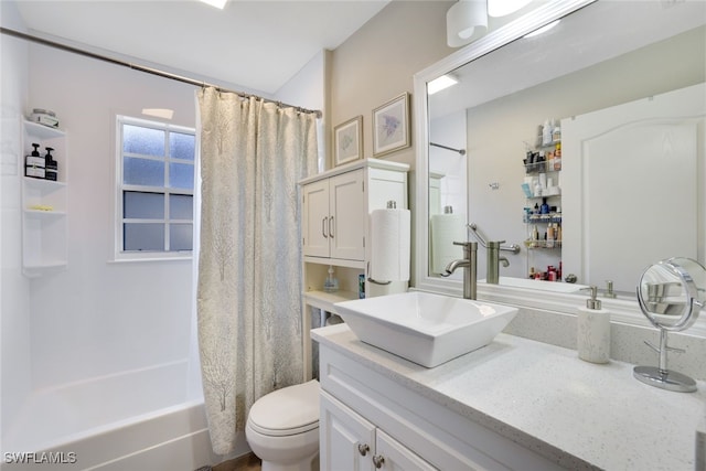 bathroom with toilet, vanity, and shower / bath combo