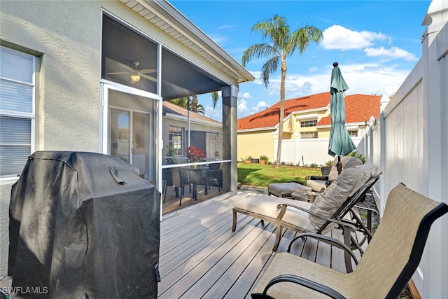 deck with fence, a sunroom, and a grill