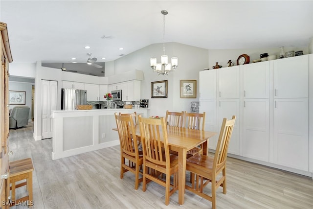 dining room with light wood finished floors, recessed lighting, ceiling fan with notable chandelier, and lofted ceiling