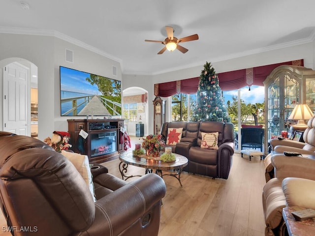 living room with ceiling fan, light hardwood / wood-style floors, and ornamental molding