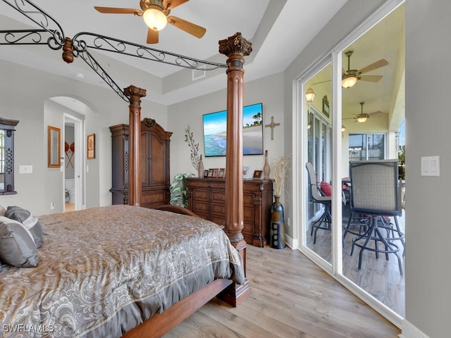 bedroom featuring access to exterior, light hardwood / wood-style flooring, and ceiling fan