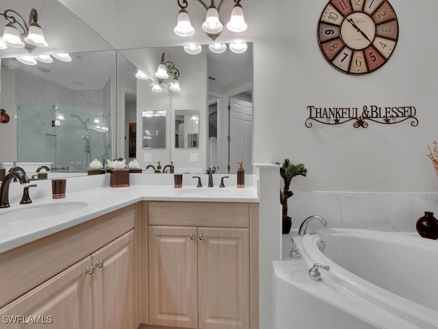 bathroom featuring double vanity, a garden tub, a shower stall, and a sink