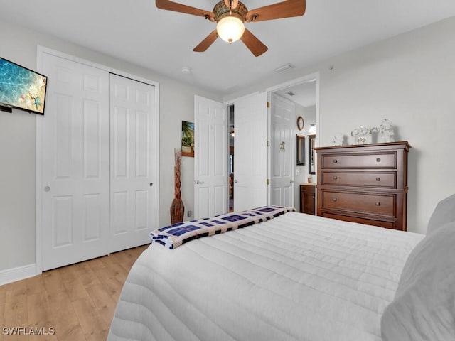 bedroom featuring ceiling fan, light hardwood / wood-style flooring, and a closet