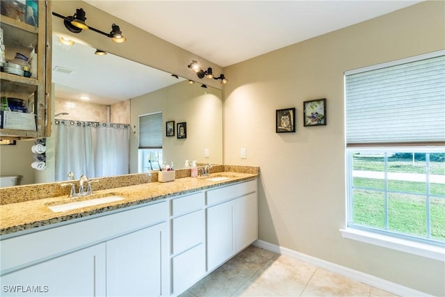 bathroom with tile patterned floors, curtained shower, vanity, and toilet