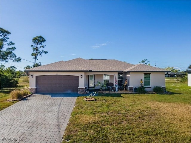 ranch-style house featuring a front lawn and a garage