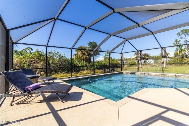 view of swimming pool featuring glass enclosure and a patio area