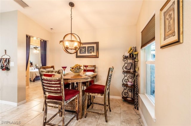 tiled dining room with lofted ceiling