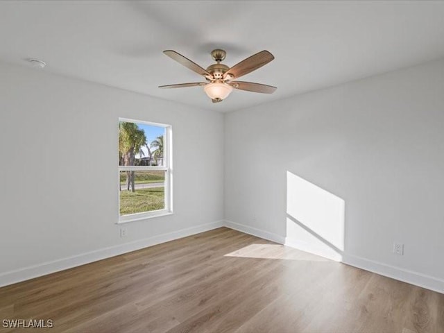 empty room featuring ceiling fan and light hardwood / wood-style flooring