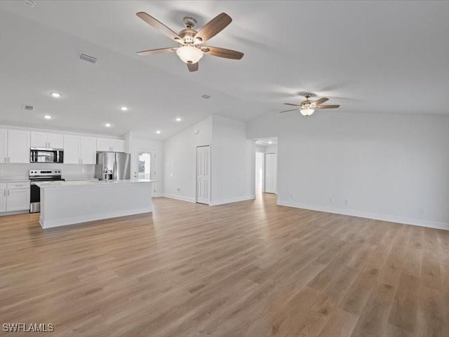 unfurnished living room featuring ceiling fan, light hardwood / wood-style floors, and vaulted ceiling