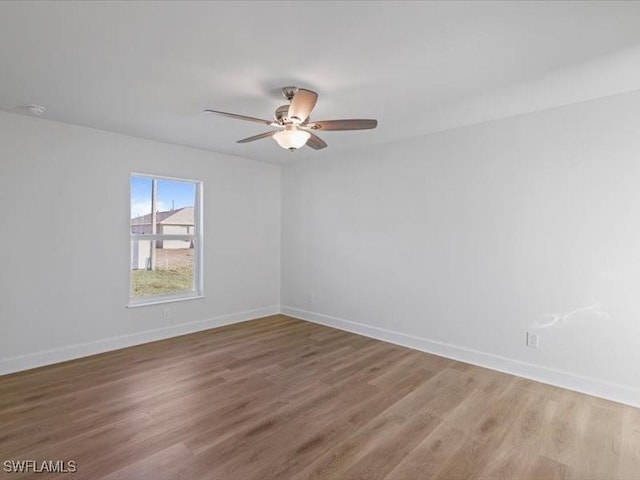 empty room with ceiling fan and hardwood / wood-style floors