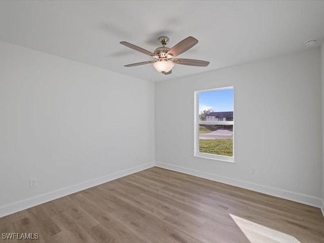 spare room with light hardwood / wood-style flooring and ceiling fan