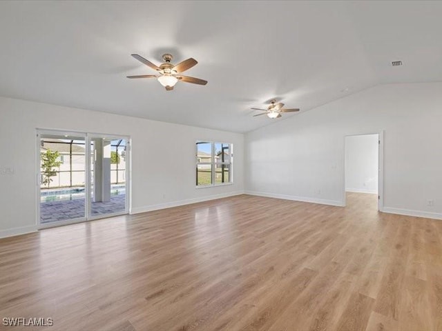 empty room with ceiling fan, light hardwood / wood-style floors, and lofted ceiling