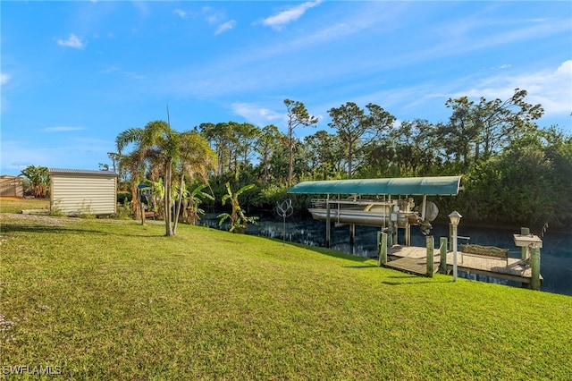 dock area with a yard and a water view