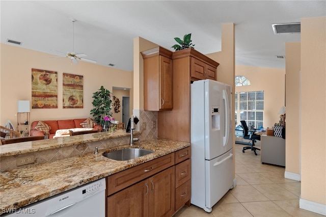 kitchen featuring white appliances, sink, ceiling fan, light stone countertops, and light tile patterned floors